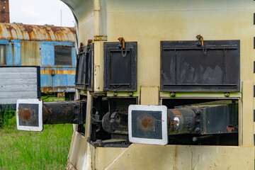 Close-up of an old railway snow plow with rusty buffers and black technical hatches. The vehicle...
