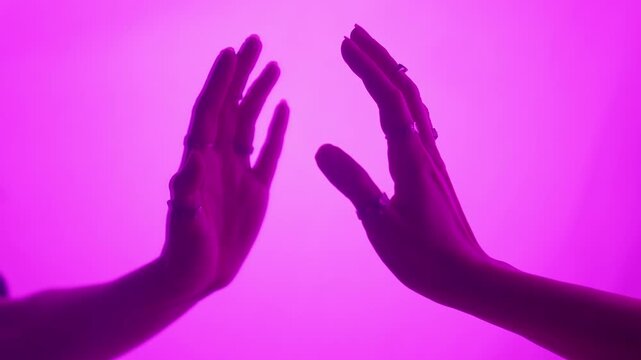 Hands Touching Visually Enhanced Vibrant Pink Glow