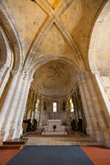 Fototapeta premium Interior of the Notre Dame Church showcasing ribbed vaults and romanesque architecture in Montagne, France