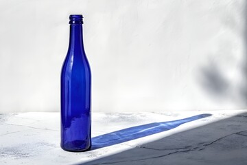 Minimalist Deep Blue Glass Bottle on White Background – High-Contrast Still Life