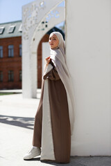 beautiful young islamic woman walking in summer city	
