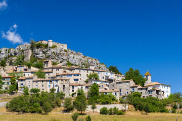 Fototapeta premium Trigance village dominating the landscape with its imposing castle in Provence, France