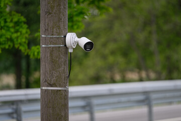 Camera on a wooden pole.
