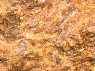 Textured Brown Stone Surface with Golden Highlights
