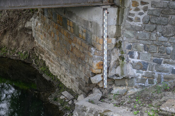 A numerical indicator on the side wall by the river.
