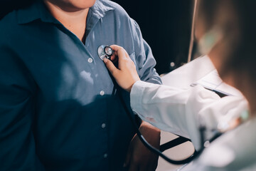 Cropped image of male doctor's hand using stethoscope to examining heartbeat and symptom of patient...