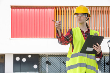 Construction manager directing team at modern building site