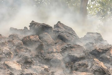 Smoky Rock Pile with Tree Canopy Glimpses in Overcast Weather
