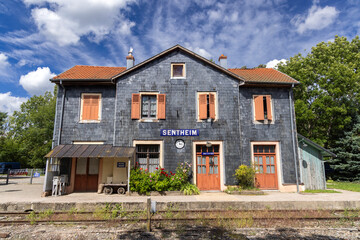 Sentheim Train Station Building with Slate Siding and Orange Shutters in Grand Est, France