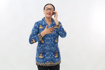 Relieved young civil servant woman getting good news from her phone while holding her chest