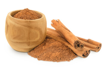 Cinnamon sticks with powder in wooden bowl isolated on white background with full depth of field