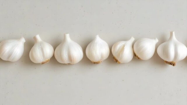 Fresh Garlic Cloves Arranged on a Neutral Background for Cooking