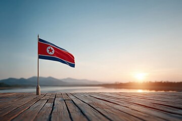 Flag of North Korea waving on a wooden dock during a sunset over tranquil waters