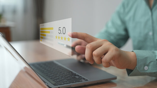 Businessman’s hand pointing at a transparent floating rating bar labeled ‘5.0’ — representing online survey, customer feedback, service review, and satisfaction scoring.