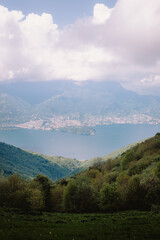 Rocky summit of Monte San Primo with directional signs and thick spring mist