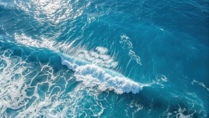 Fototapeta premium A single white wave crests on a cerulean ocean, capturing the beauty of the ocean's natural rhythm