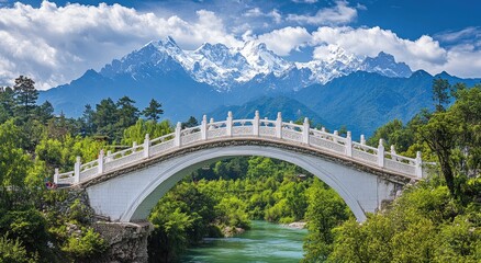 Majestic arch bridge over a serene river, with snow-capped mountains in the background. Lush greenery surrounds the bridge, creating a picturesque landscape