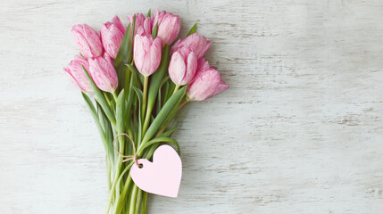 Bouquet of Pink Tulips with Heart-Shaped Tag on Rustic Wooden Surface