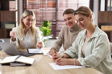 Couple having meeting with banker at desk in office