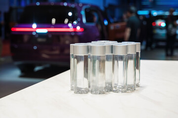 Delivery of drinking water. Visitors enjoy complimentary water while exploring the car show in a lively exhibition setting.