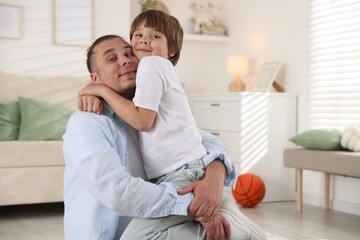 Fototapeta premium Portrait of father and his son at home, space for text