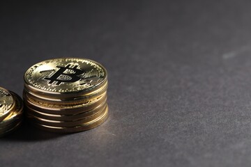 Cryptocurrency. Golden bitcoins on grey background, closeup. Space for text