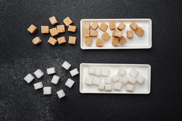 Different types of sugar cubes displayed on trays in a kitchen setting