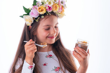Beautiful bulgarian girl wearing traditional folklore costume eating bulgarian sweet meal ashura...