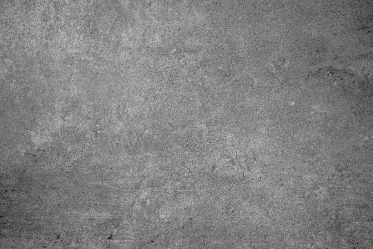 Gray concrete wall texture with natural surface imperfections and subtle cracks