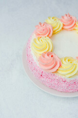 Delicious dessert decorated with pink and yellow frosting circles