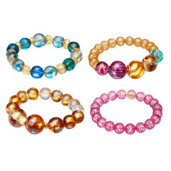 Obraz premium A display of four beaded bracelets in different colors and styles against a black background showcase jewelry