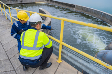 Environmental engineers work at wastewater treatment plants,Water supply engineering working at Water recycling plant for reuse,Technicians and engineers discuss work together.