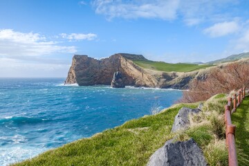 South coast of Sao Jorge (Azores islands) near Velas with volcanic rock Morro de Lemos. Coastal cliffs and turquoise waters. Oceanic landscape with rugged rock formations. NBeauty of the archipelago