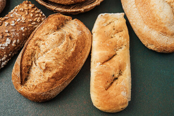 Freshly baked bread assortment arranged on a dark surface