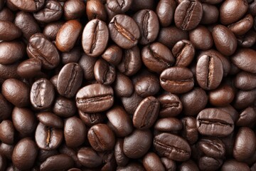 Fototapeta premium Roasted Coffee Beans Texture - Aromatic, rich, dark roasted coffee beans, symbolizing energy, warmth, morning ritual, and a comforting beverage. Perfect for coffee packaging or blog posts