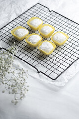Deliciously sweet desserts cooling on a wire rack with delicate flowers