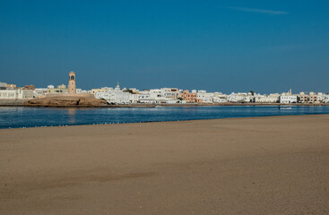 Oman, Middle East, 03-11-2025: panoramic view of the main beach of Sur, the capital city of Ash Sharqiyah South Governorate, on the coast of the Gulf of Oman, and the skyline of the old town