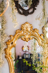 Vintage mirror framed by delicate hanging flowers in an elegant setting