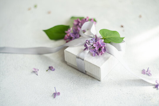 Elegant white gift box adorned with lilac and ribbon