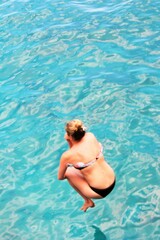girl jump in sea unrecognizable