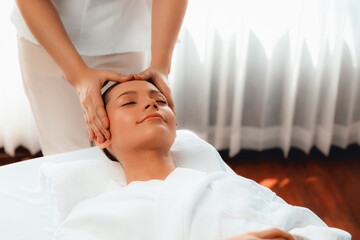 Caucasian woman enjoying relaxing anti-stress head massage and pampering facial beauty skin...