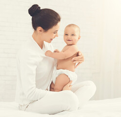 Happy maternity leave time. Mother enjoying pastime with her lovely baby, free space