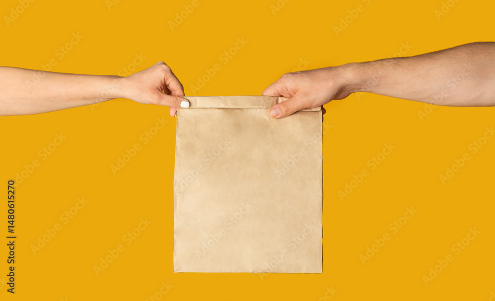 Poster takeaway food concept. delivery man giving paper bag with empty space for design to client, orange b