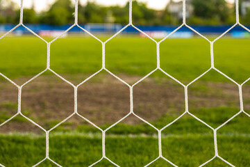 Fototapeta premium Close-Up of Soccer Net on Green Grass – Detail of Football Goal and Sports Concept