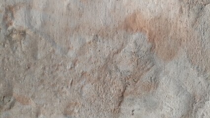 Weathered Wall with Stains. A photograph of a weathered wall showing visible stains and a rough texture, suggesting exposure and age. Ideal for backgrounds or illustrating aged surfaces.