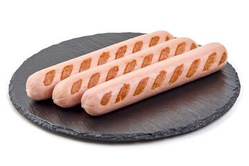 Grilled sausages on a black slate plate isolated on white background.