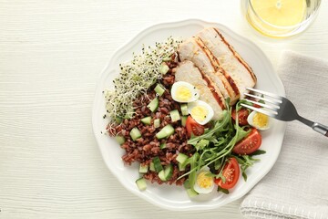 Delicious salad with brown rice and drink on white wooden table, top view. Space for text