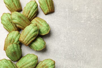 Tasty matcha madeleine cakes on light table, flat lay. Space for text