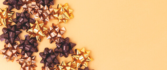 Banner with golden metallic bows made from ribbons.