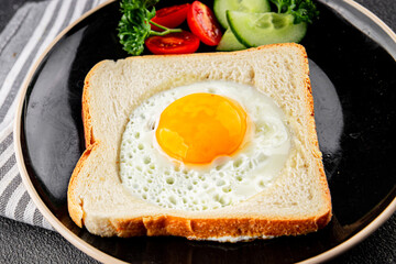 Fried gashouse eggs in bread egg in the basket delicious snack breakfast in a bowl fresh delicious gourmet food background on the table rustic food top view copy space
